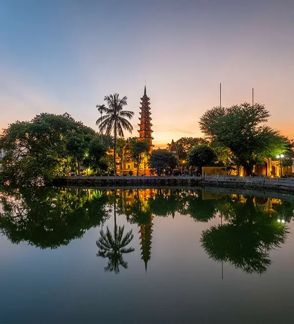 Tran Quoc Pagoda reflecting on West Lake at sunset in Hanoi