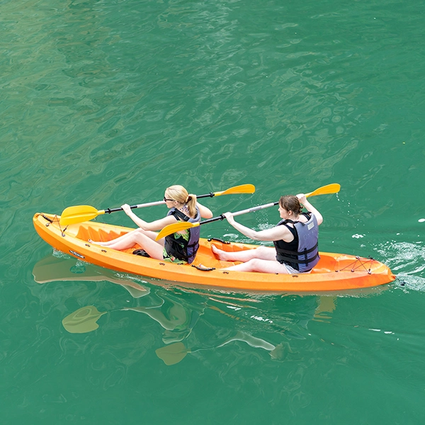 Two travelers kayaking across the emerald waters of Halong Bay