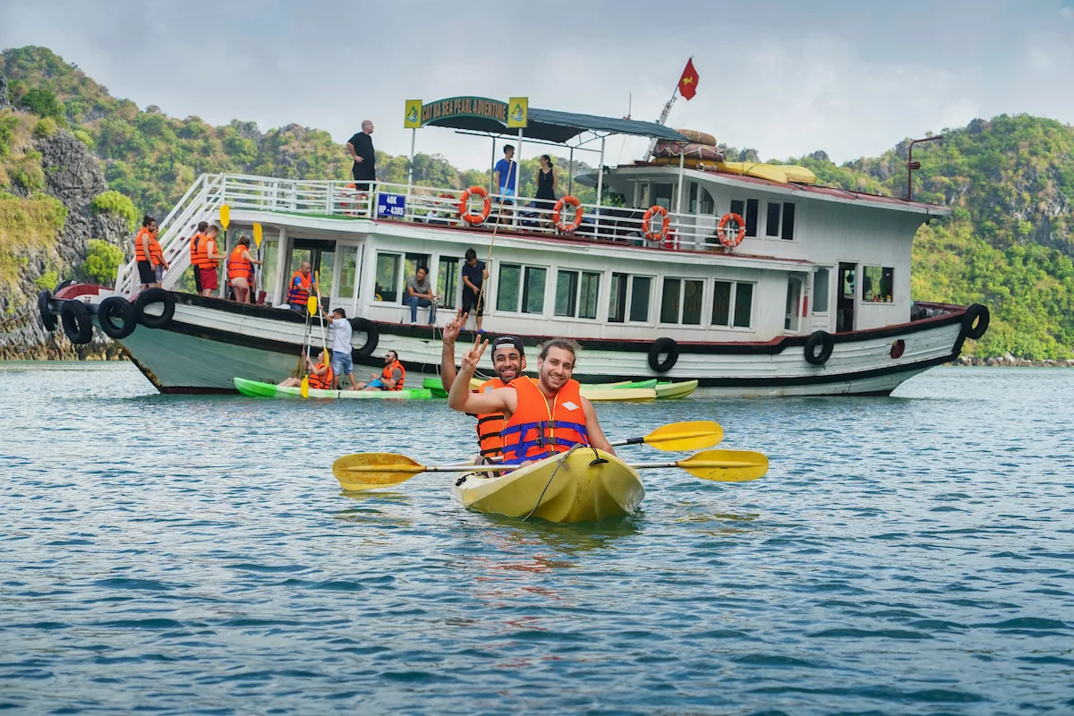Tourists kayaking among limestone islands in Lan Ha Bay, Vietnam