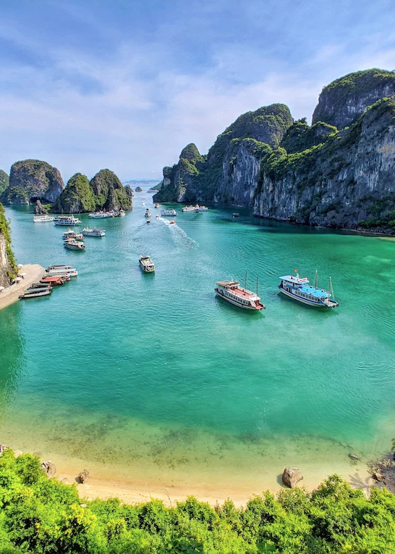 Tourist boats among limestone karsts in Halong Bay