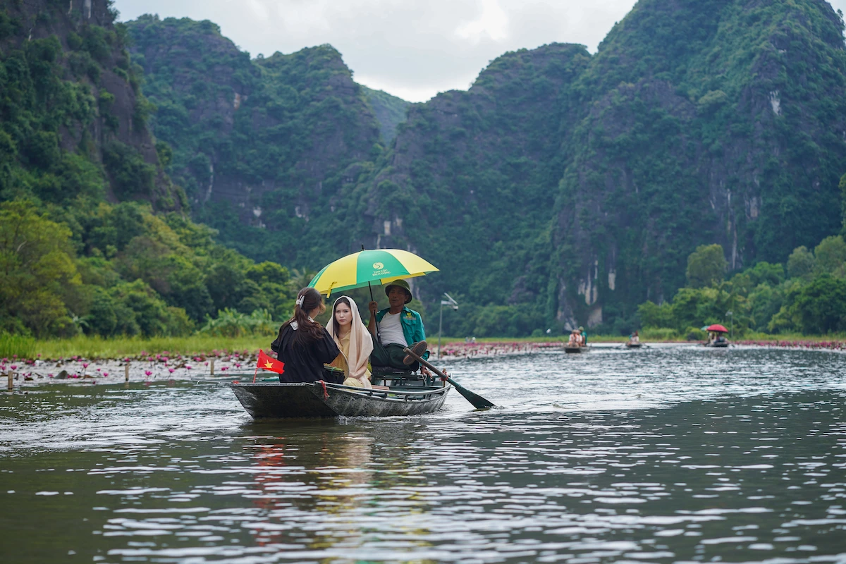 Traditional sampan boat ride along limestone karsts in Tam Coc Ninh Binh