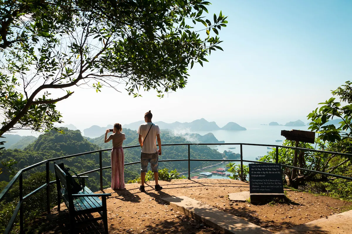 Travelers enjoying a panoramic viewpoint overlooking Lan Ha Bay