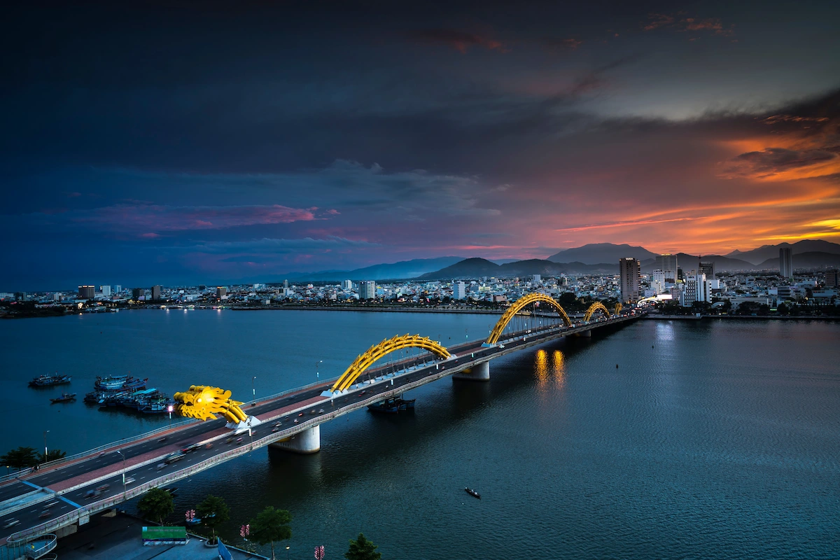 Dragon Bridge and illuminated city skyline at dusk beside the Han River