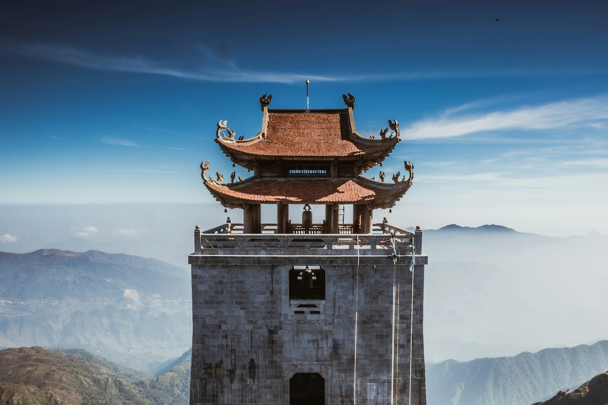 Temple pavilion overlooking distant mountains at Fansipan summit