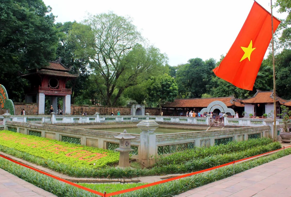 Traditional courtyard and Vietnamese flag at Hanoi's Temple of Literature