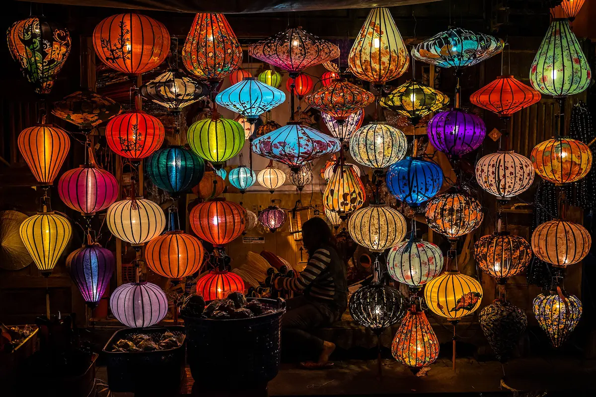Colorful traditional lanterns illuminating a shop in Hoi An at night