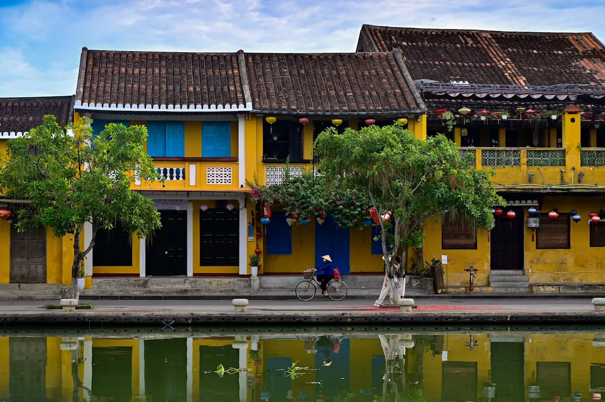 Yellow historic houses with blue shutters along the Hoi An riverside