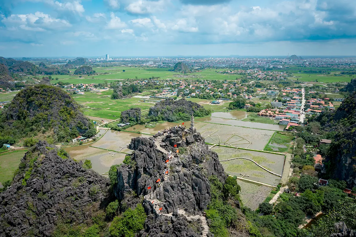 Stone steps lead to a panoramic viewpoint over Ninh Binh’s limestone peaks and rice fields