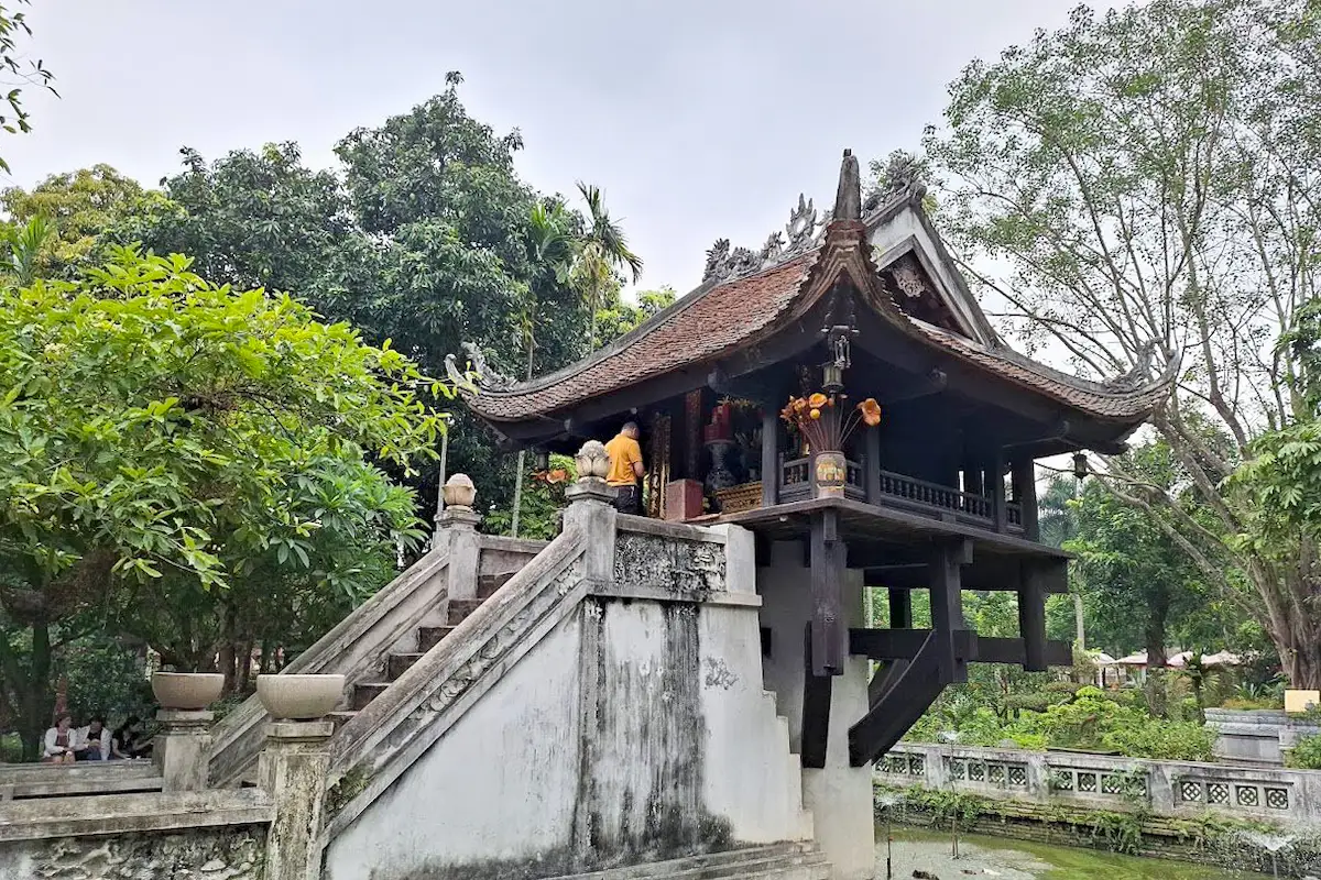 Hanoi's One Pillar Pagoda standing above a stone pond surrounded by trees