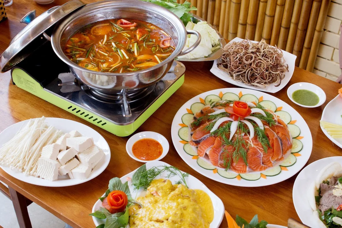 Sapa travel guide: salmon hot pot served with fresh vegetables and tofu